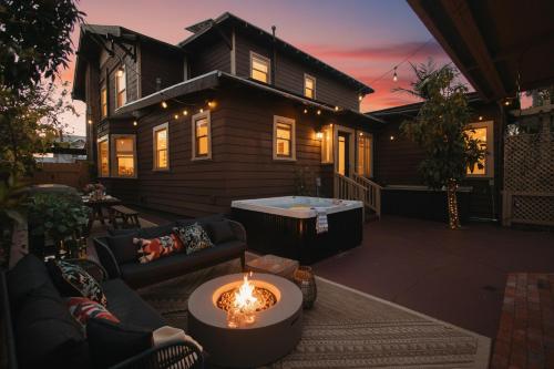a house with a patio with a candle in the yard at Balboa 6BR Mansion with Hot Tub and Game Room in San Diego
