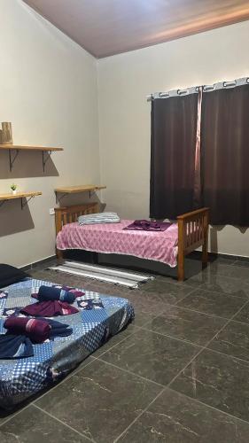 two beds sitting in a room with at Casa da Barra in Ubatuba
