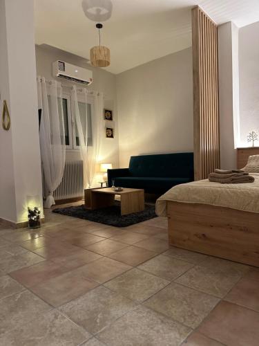 a living room with a bed and a couch at Little Florina Nest in Florina