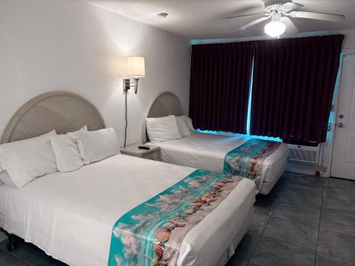 a hotel room with two beds and a ceiling fan at Apollo Motel in Wildwood Crest