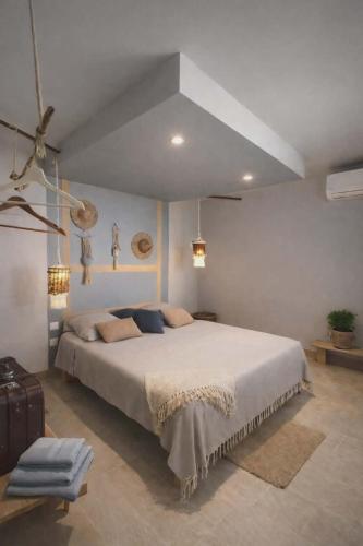 a bedroom with a large bed in a room at Le temps d'un repos in Vieux-Habitants
