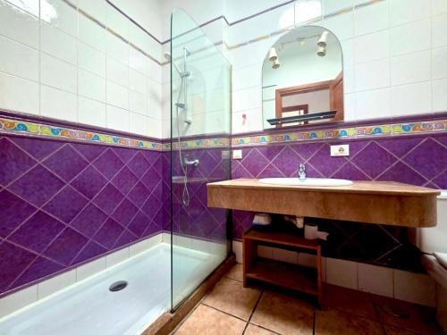 a bathroom with a sink and a shower at Famara Chill House in Famara