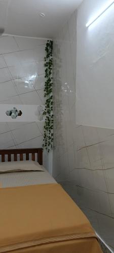 a bedroom with a bed with a plant on the wall at AI cube Homes in Pīrmed