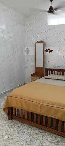 a bedroom with a bed with a mirror and a chair at AI cube Homes in Pīrmed