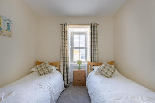 two twin beds in a room with a window at 3 Bed in Drummore oc-k30214 in Drummore