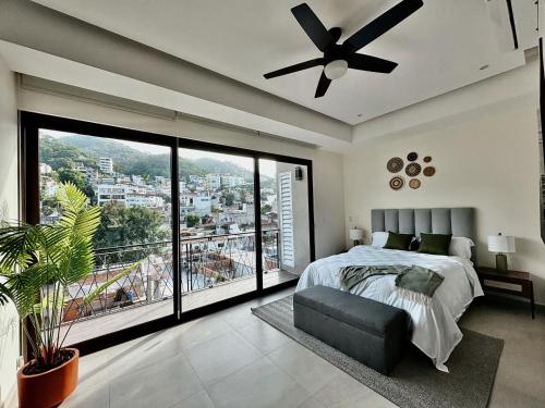 a bedroom with a bed and a ceiling fan at OVATA 401- Zona Romántica in Puerto Vallarta