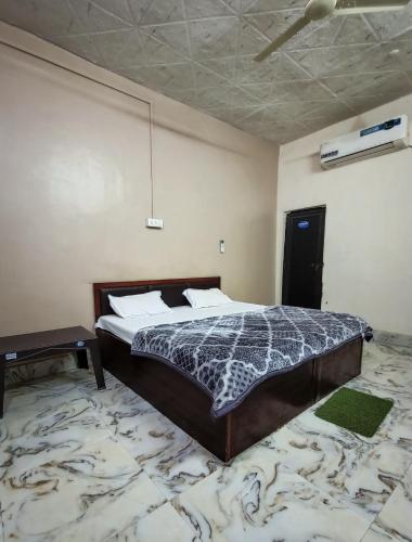 a bedroom with a bed in a room at Brajrani Hotel in Datia