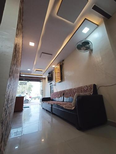 a living room with a couch in a room at Brajrani Hotel in Datia
