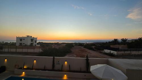 een uitzicht op een zonsondergang vanaf het dak van een huis bij RV Villas Deadsea in Sowayma
