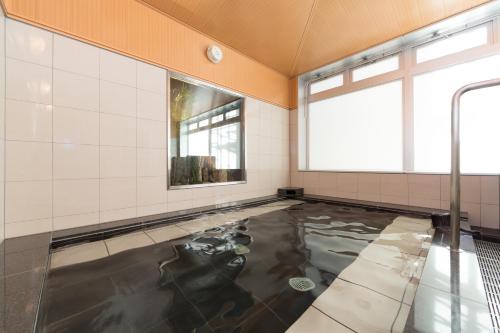 um quarto com piscina de água no chão em Sanco Inn Tsu Ekimae em Tsu