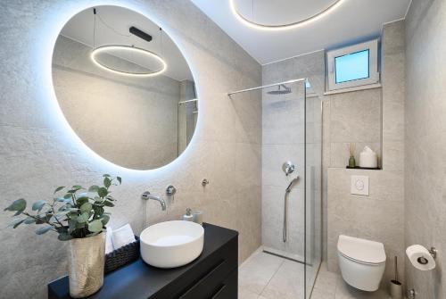 a bathroom with a sink and a mirror at Tina's Tiny Beach House in Slatine