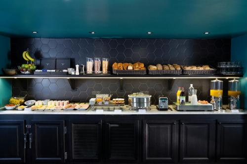 a buffet line with pastries and other food items at H&ocirc;tel Diana Dauphine in Strasbourg
