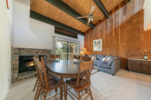 a dining room with a table and a fireplace at Kingswood Pines in Kings Beach