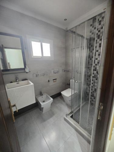 a bathroom with a shower and a toilet and a sink at Hostel Dar Khelifa in Tétouan