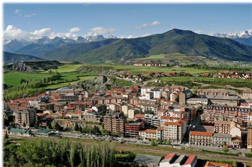 an aerial view of a city with mountains in the background at SNÖ Hotel Ciudad de Sabiñánigo in Sabiñánigo
