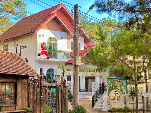 a house with a santa clause on the balcony at Thalia Home Măng Đen in Kon Plong