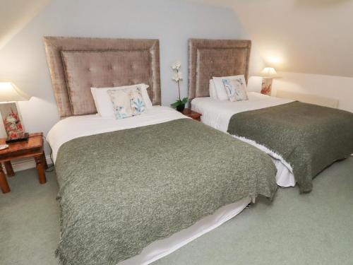 En eller flere senge i et værelse på Grange Cottage