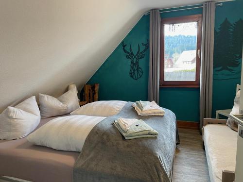 een slaapkamer met een bed met twee handdoeken erop bij Gästehaus Sandvoss in Titisee-Neustadt