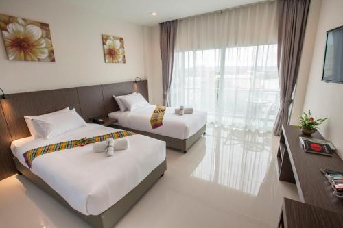 Postel nebo postele na pokoji v ubytování The Elysium Residence - SHA Extra Plus
