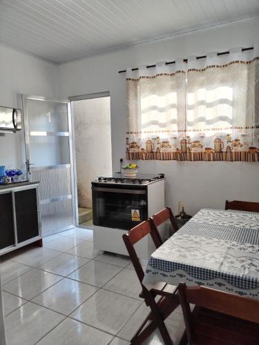 a kitchen with a table and a stove in it at Casa Zago 1 in Santa Maria Madalena