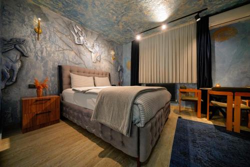 a bedroom with a bed and a table in a room at Cappadocia Divin House in Göreme