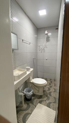 a bathroom with a toilet and a sink at Hotel Beira Rio in Oiapoque