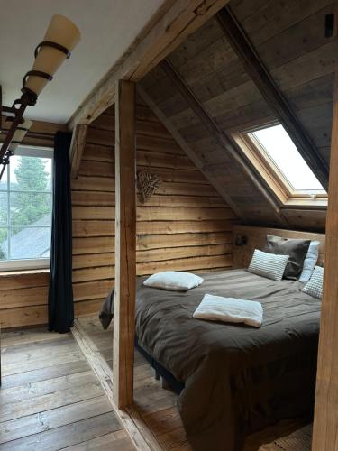 a bedroom with a large bed in a log cabin at Tante Hanna in Winterberg