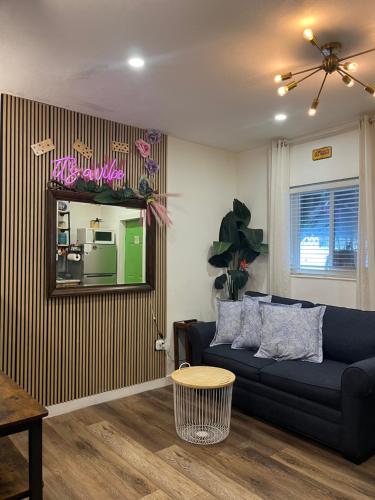 a living room with a blue couch and a mirror at Stunning Little Havana Suites Close to airport, Calle Ocho, Brickell, Wynwood and the Beaches - Free Parking in Miami