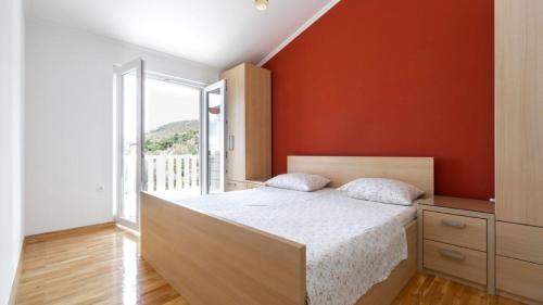 a bedroom with a bed with an orange wall at Villa Vanilla by Villas Guide in Smokvica
