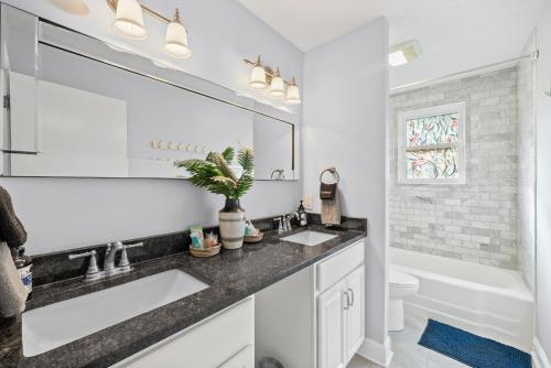 a bathroom with two sinks and a large mirror at Nanas Nook on Hickory Grove in Clarksville