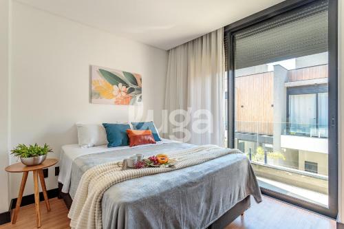 a bedroom with a bed and a large window at LUGA Relax House with Jacuzzi in Palhoça