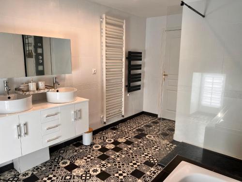 un bagno con due lavandini e una doccia di Ancien Château viticole a Bourg-sur-Gironde