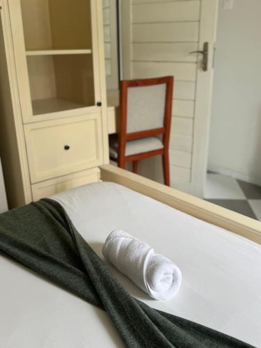 a white shoe sitting on a bed in a room at Peter's Nest in Livingstone