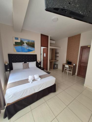 a bedroom with a large bed with two dishes on it at Residencial Lago Verde in Tarapoto
