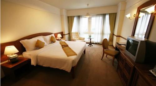 a hotel room with a bed and a television at Poipet Resort & Casino in Krong Poi Pet
