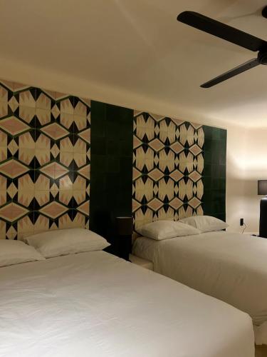 เตียงในห้องที่ Chamela Boutique Apartments