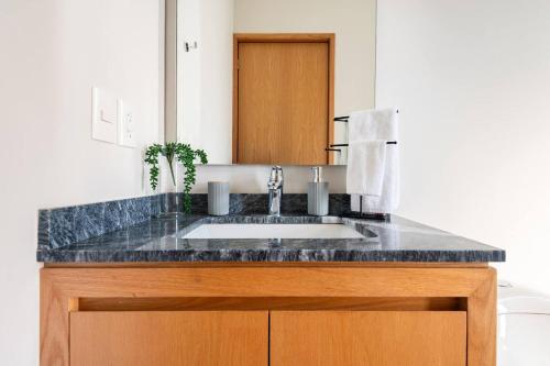 a bathroom counter with a sink and a mirror at 105 Downtown cerca de playa y el malecón in Puerto Vallarta