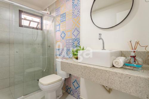 a bathroom with a toilet and a sink and a mirror at Vieira Eco Inn – Deluxe Suite Thiago #3 in Orleans