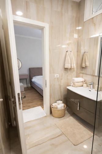 a bathroom with a sink and a shower at Liqeni New Apartament in Tirana