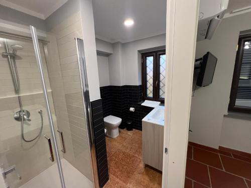 a bathroom with a shower and a sink and a toilet at InVilla in Naples