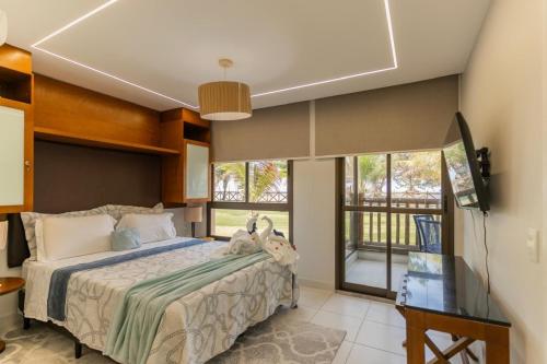 a bedroom with a bed with two stuffed animals on it at Bungalow Frente Mar N 101 in Caucaia