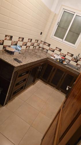 a kitchen with a counter top and a window at Maison in Salé