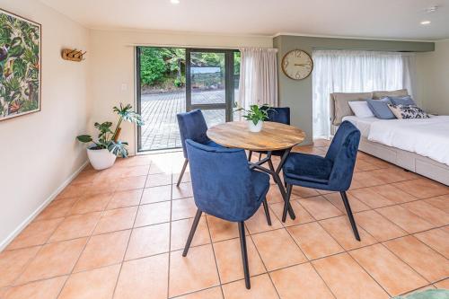 a room with a table and chairs and a bed at Hillside Haven in Whanganui