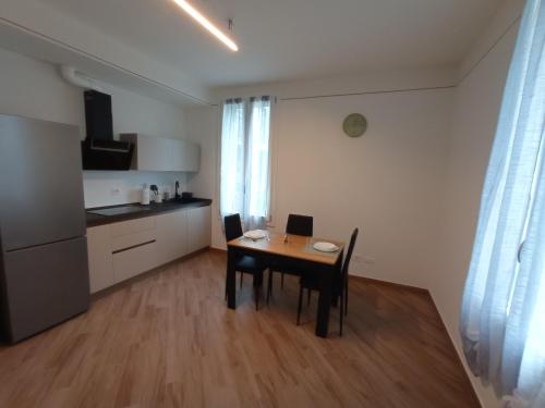 een kamer met een tafel en stoelen en een keuken bij Hello Parma in Parma