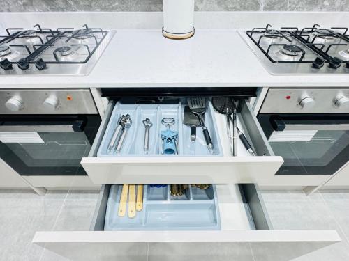 a kitchen drawer with utensils in it at Letza House - Private En-Suite Rooms near Cardiff City Centre in Cardiff