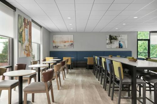 a restaurant with tables and chairs in a room at City Express by Marriott Charlotte South End in Charlotte