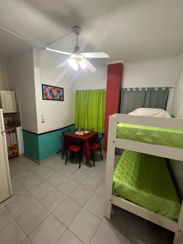 a bedroom with a bunk bed and a table with a tableablish at La casa del varón in Mina Clavero