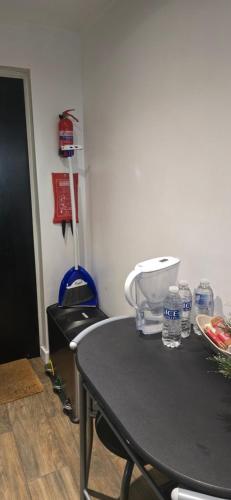 a table with water bottles on top of it at Exclusive Private One Bedroom Suite in London