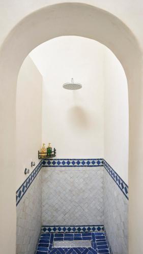 a bathroom with a blue and white tiled floor at Bab Akoul Palmeraie - Boutique Hotel & Spa in Marrakesh