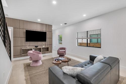 a living room with a couch and a flat screen tv at Luxury Home with Inter Miami Theme in Miami